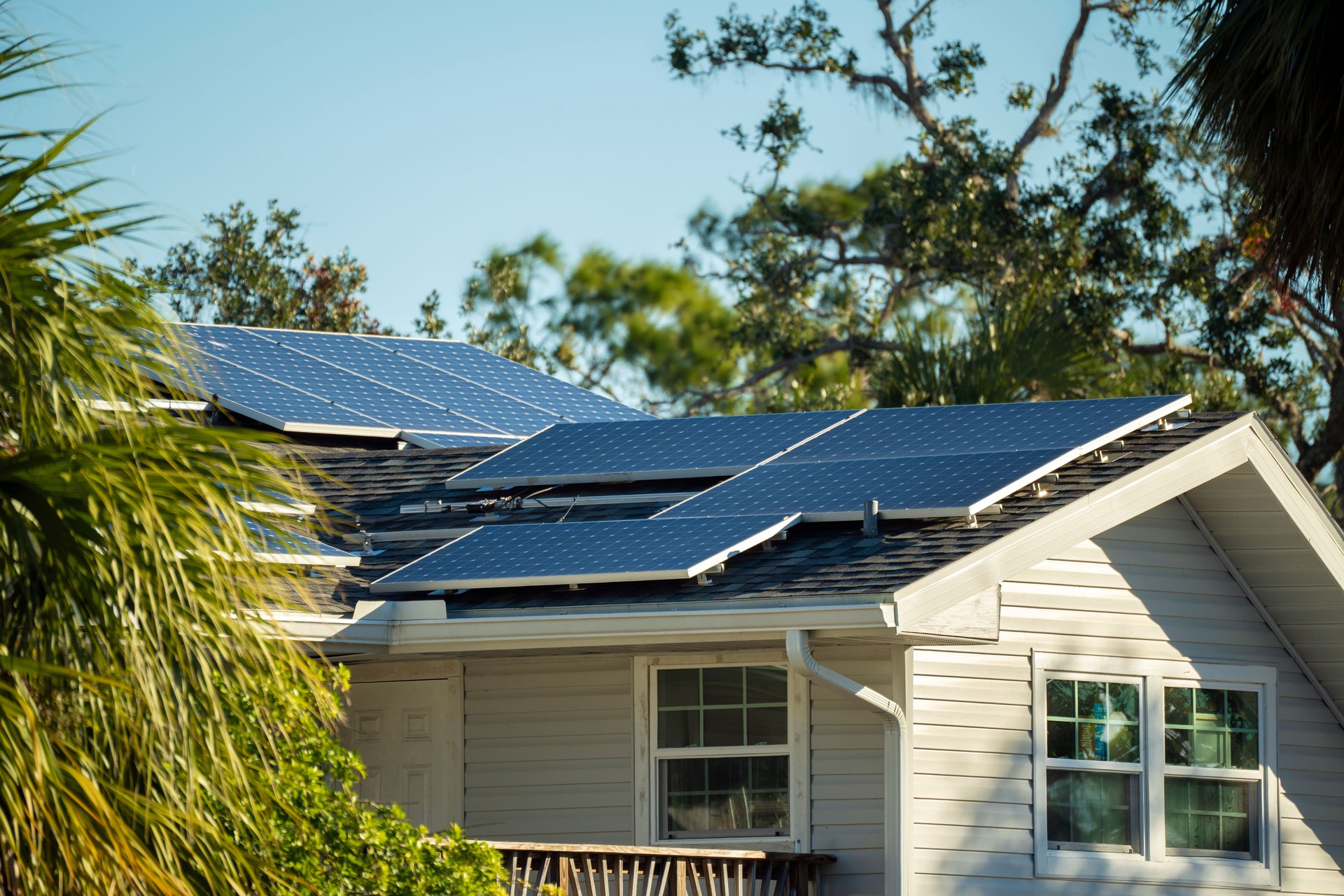 Private home roof covered with solar photovoltaic panels for generating of clean ecological electric energy in suburban rural town area. Concept of autonomous house